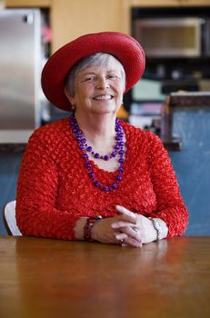 Friendly senior woman wearing a red hat