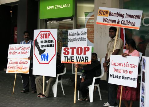 AUCKLAND; NEW ZEALAND - FEBRUARY 02: People standing in a row on a protest rally in the street Queens in the city of Auckland. Auckland meeting in protest February 02; 2009 in Auckland; New Zealand.