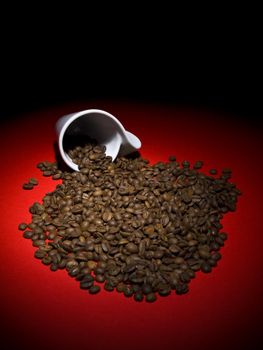 A fallen cup with coffee beans spread out.