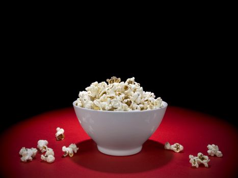 A bowl full of popcorn under the spotlight.