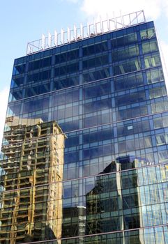 Facade of a building with reflections of other  buildings