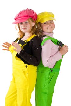 two girls wearing colorfull dungarees isolated on white