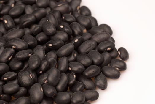 Stack of dry black beans, frijoles, with copy space