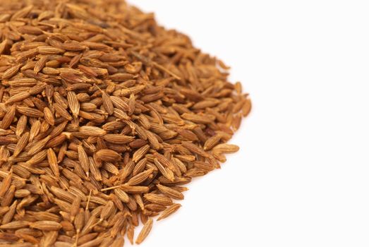 A stack of cumin seeds with copy space