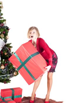 Happy woman with Christmas presents and tree isolated on white