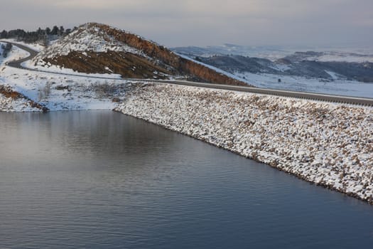 mountain lake, rock cliff, dam and windy road - Horsetooth Reservoir near Fort Collins, Colorado in winter scenery