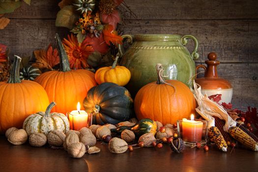 Festive autumn variety of gourds and pumpkins with wood background