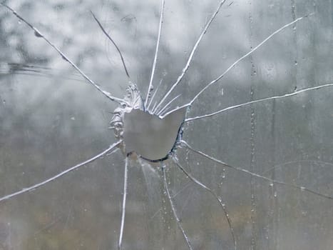 Big hole in cracked  glass