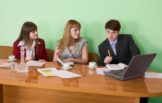 Business team sits at the big table