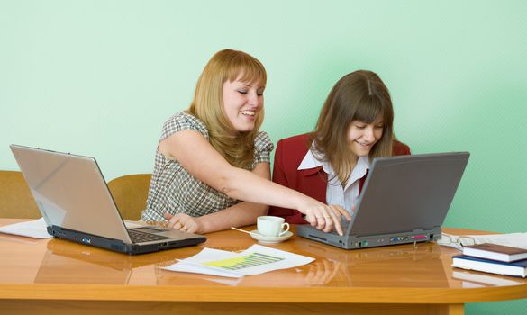 Young girls work sitting at a table