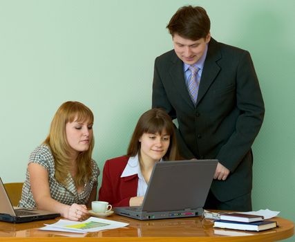 Girls sitting at a desktop and their chief