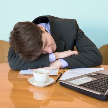 Young businessman has fallen asleep sitting at meeting