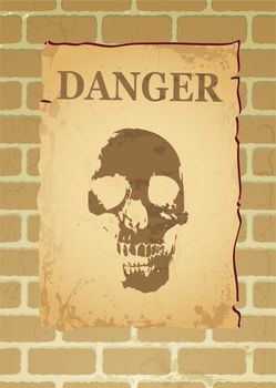 Poster on a brick wall with a skull and the word danger