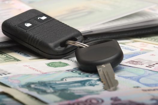 Keys and documents from the car against from monetary denominations.