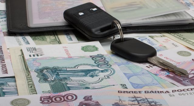 Keys and documents from the car against from monetary denominations.