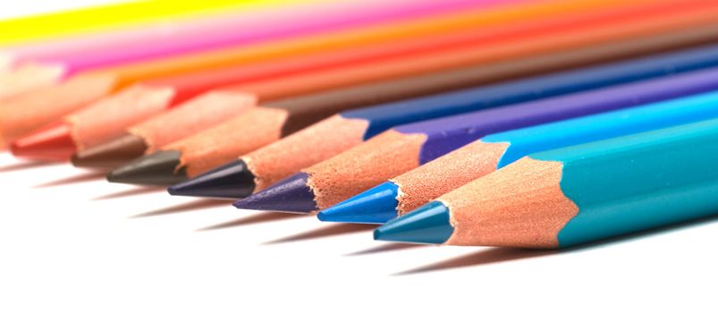 Set of colour pencils on a white background. Close up