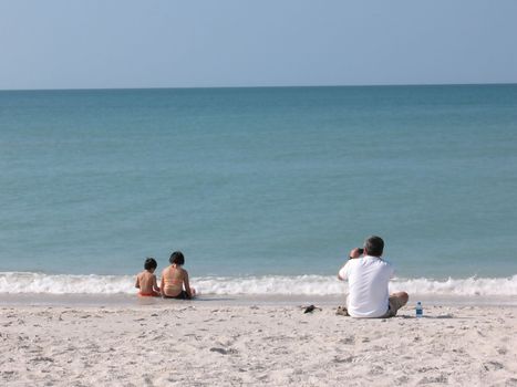 A family enjoying the water and sand at a Florida beach