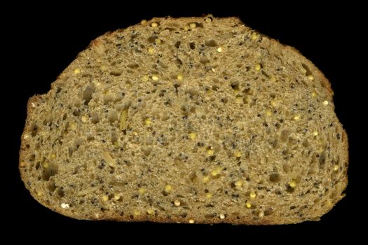 slice of whole wheat grain bread with sesame, pumpkin, puppy and millet seeds isolated on black