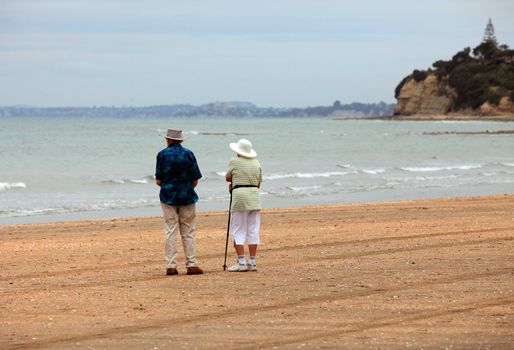 Senior couple on the beach at sunset