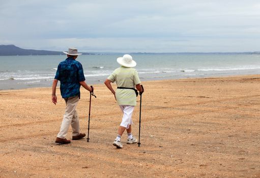 Senior couple on the beach at sunset