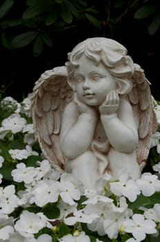 Angel figure in a bed at the cemetery.