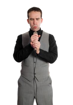 A young businessman singing for fun into a microphone, isolated against a white background