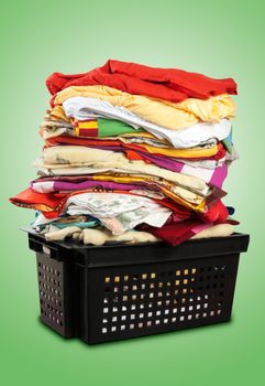 Colorful stack of bed-clothes in plastic crate. Clipping paths included