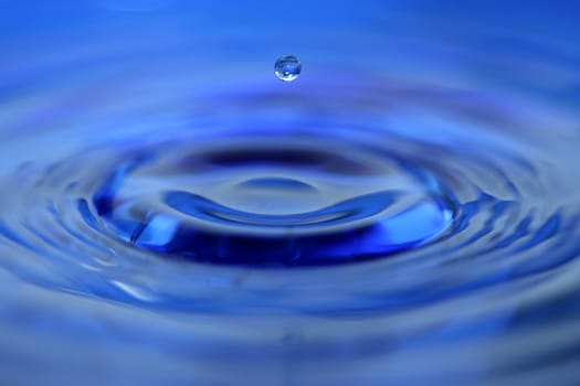 A Blue water droplet falling