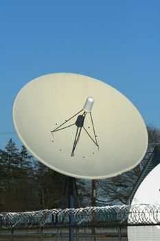 A satellite dish against blue sky