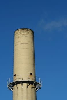 A smokestack against blue sky