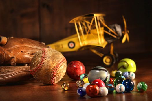 Old baseball and glove with antique toys on wood floor
