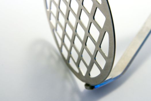 Single chrome potato masher with grid front on a white background