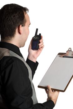 A young man talking on a walkie-talkie while holding a clipboard with blank paper on it, isolated against a white background