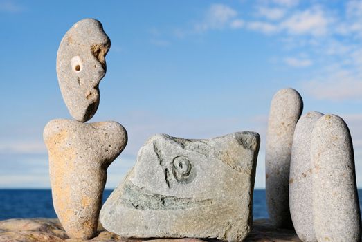 Sculptural group of stone idols on the shore of ocean
