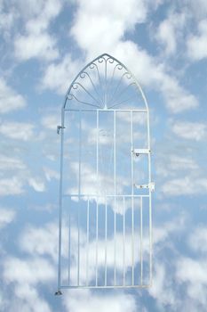 a white wrought iron gate against a cloudy background (with clipping path) depicting heaven