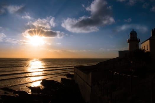 lighthouse captured with the sun behind it