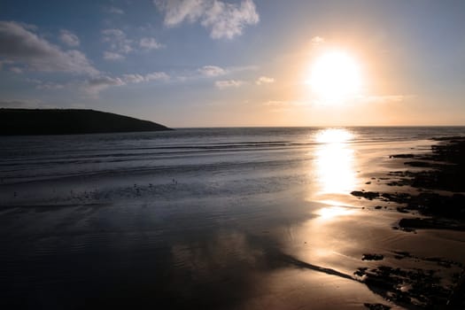 the waves with reflection crashing in on youghal beach ireland