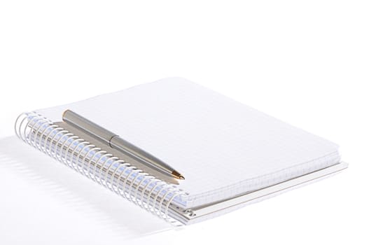 isolated open notebok with metal pen on a white background