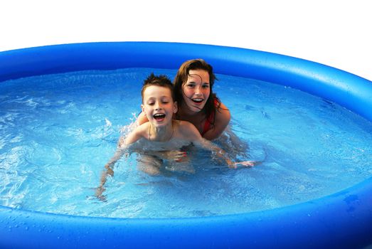 Two kids having fun in a swimming pool.