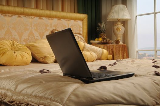 notebook on a luxurious bed in a hotel