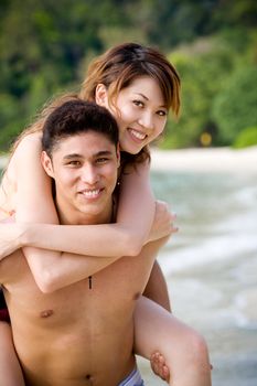 couple enjoying romantic time by the tropical beach