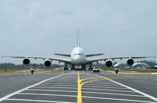 Very big airplane being towed at an airport