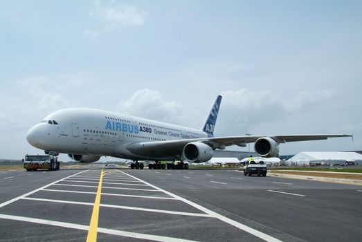 Front view of Airbus A380 being towed during the Singapore Airshow, February 2008. Very wide perspective.