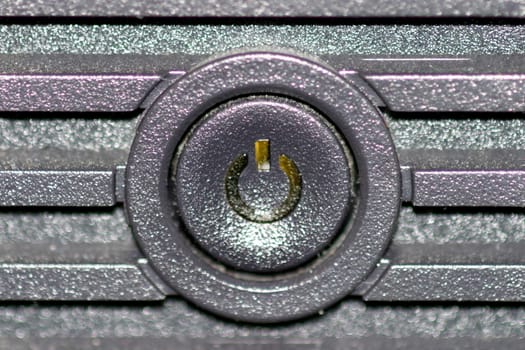 Black on and off button from the front of a computer