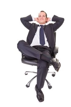 Relaxed young businessman, sitting on a chair. Isolated on white background.