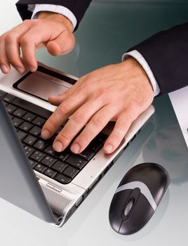 Male hands typing on a laptop computer.