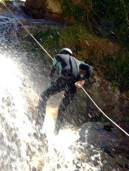 Men descending waterfall in Portugal