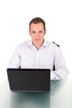 A young handsome man working on a laptop.