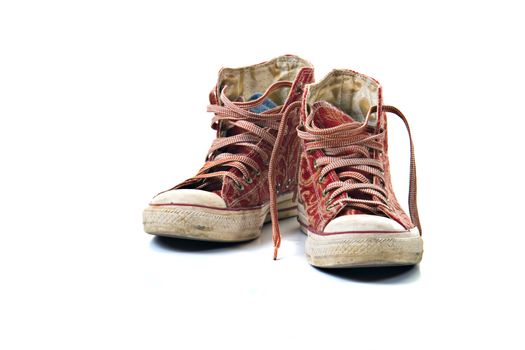 A pair of old sneakers, isolated on white background.