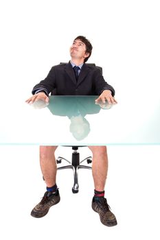 Humorous concept: A businessman, on a suit, sitting on his desk, without pants.